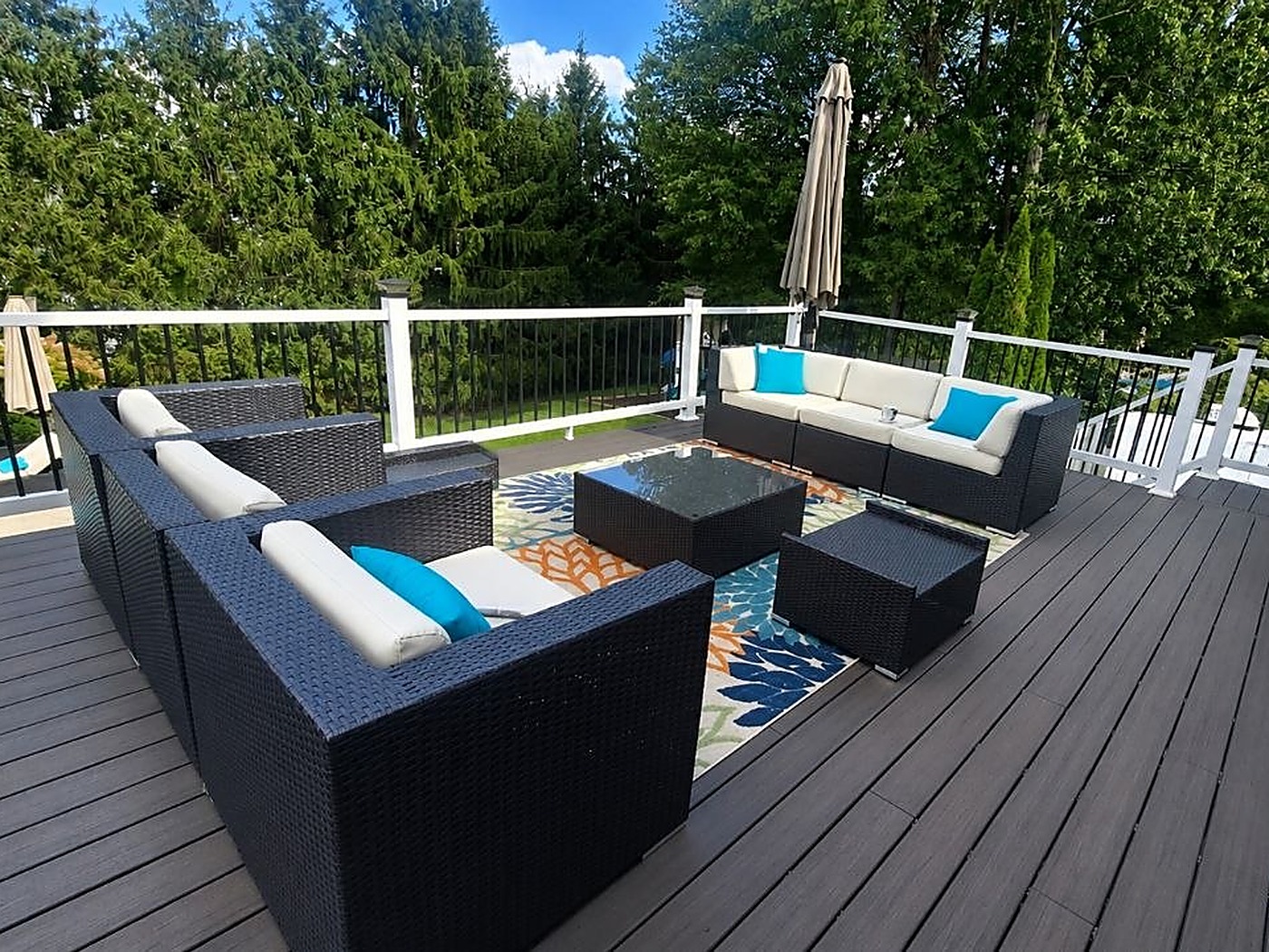 Custom deck with outdoor furniture and black-metal spindle railing